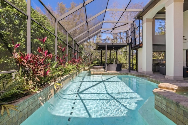 pool with glass enclosure and a patio area