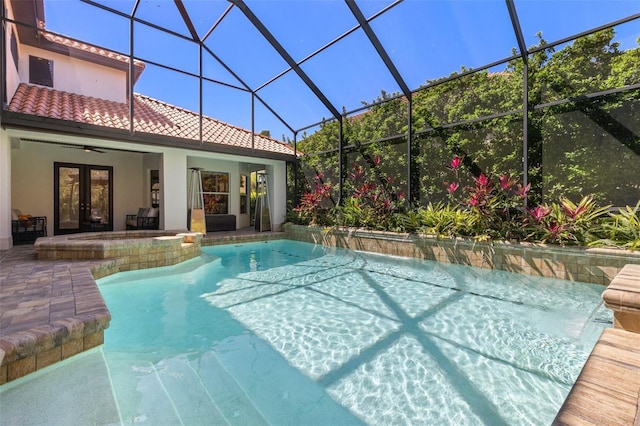 outdoor pool featuring glass enclosure, a patio area, french doors, and ceiling fan