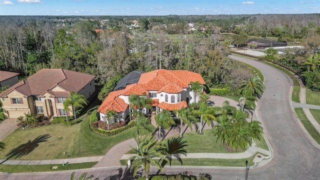 drone / aerial view featuring a view of trees