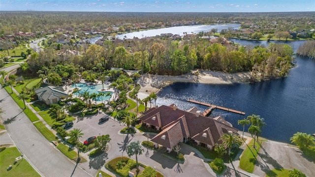 drone / aerial view with a forest view and a water view