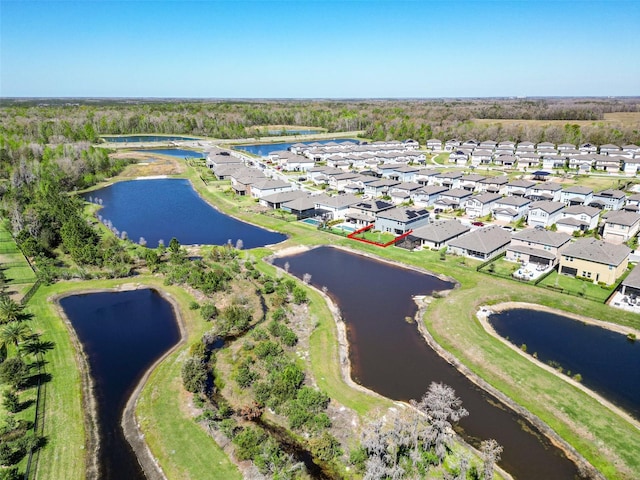 drone / aerial view featuring a water view and a residential view