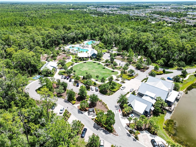 aerial view featuring a water view and a view of trees