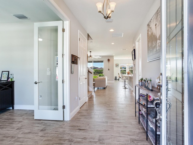 foyer featuring wood finish floors, recessed lighting, visible vents, and baseboards