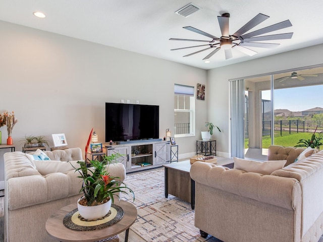 living room with a ceiling fan, recessed lighting, visible vents, and baseboards