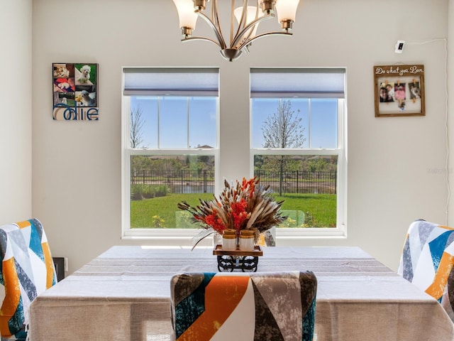 dining space featuring a notable chandelier and a healthy amount of sunlight