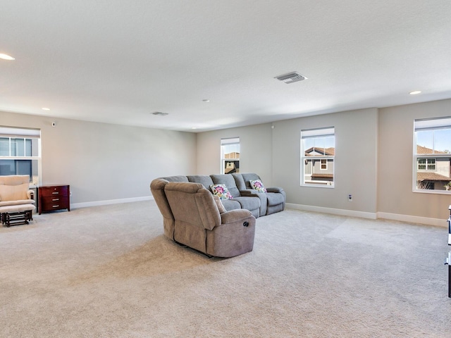 carpeted living room with baseboards, visible vents, and recessed lighting