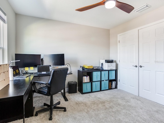 carpeted home office featuring ceiling fan and visible vents