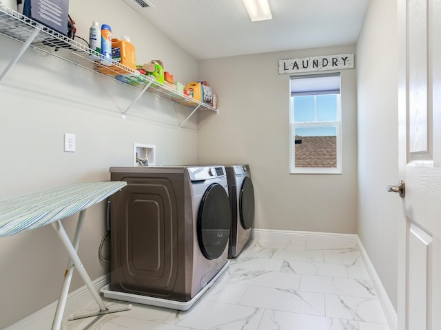 laundry area with marble finish floor, baseboards, laundry area, and washing machine and clothes dryer