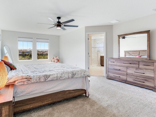 bedroom featuring carpet floors, ensuite bath, visible vents, and ceiling fan