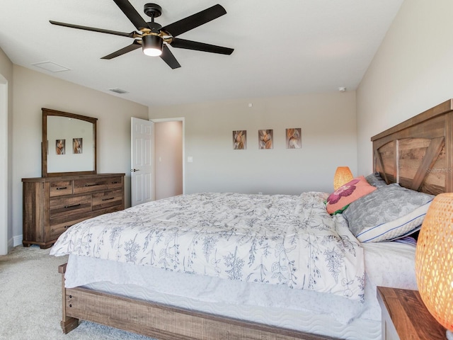 carpeted bedroom featuring ceiling fan and visible vents