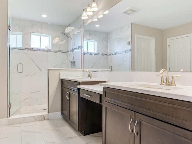 bathroom featuring recessed lighting, marble finish floor, vanity, and a marble finish shower