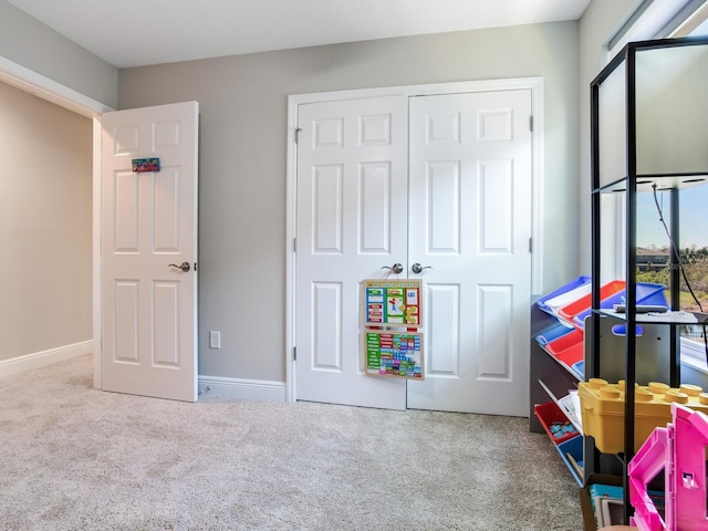 recreation room featuring carpet and baseboards