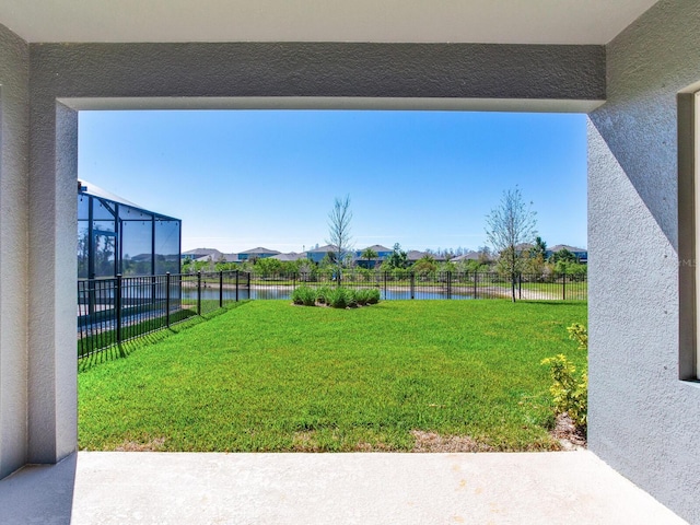 view of yard with a water view and a fenced backyard