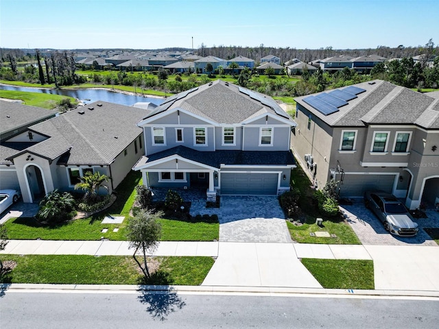 bird's eye view featuring a water view and a residential view
