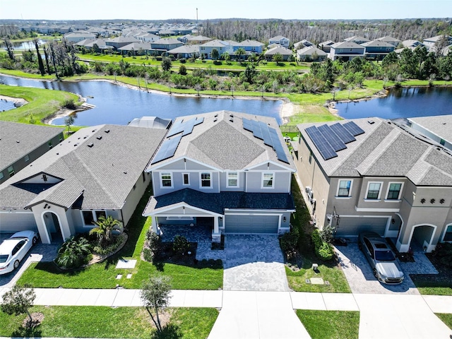birds eye view of property with a residential view and a water view