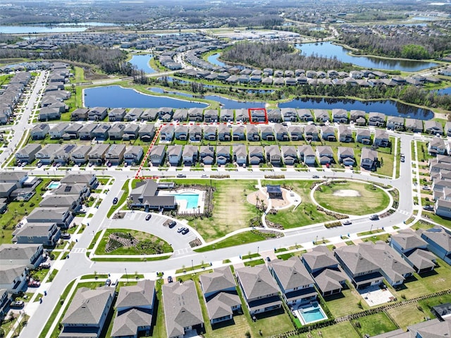 drone / aerial view featuring a water view and a residential view