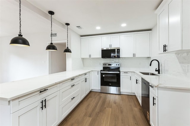 kitchen featuring light wood-style flooring, a sink, stainless steel range with electric stovetop, dishwasher, and a peninsula