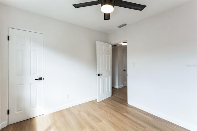 unfurnished bedroom with baseboards, ceiling fan, visible vents, and light wood-style floors