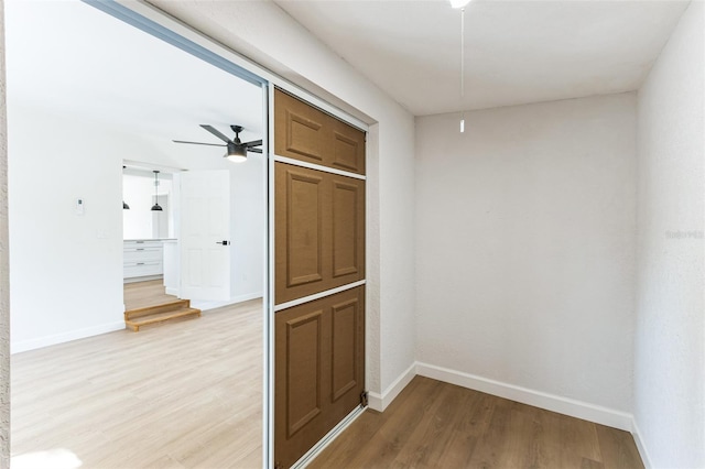 hallway with light wood-style floors and baseboards