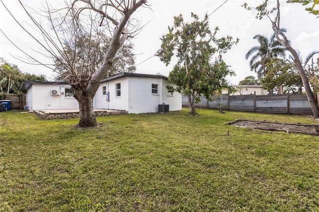 view of yard with cooling unit and fence