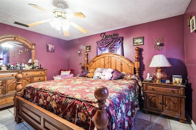 bedroom with a ceiling fan, visible vents, a textured ceiling, and light tile patterned floors