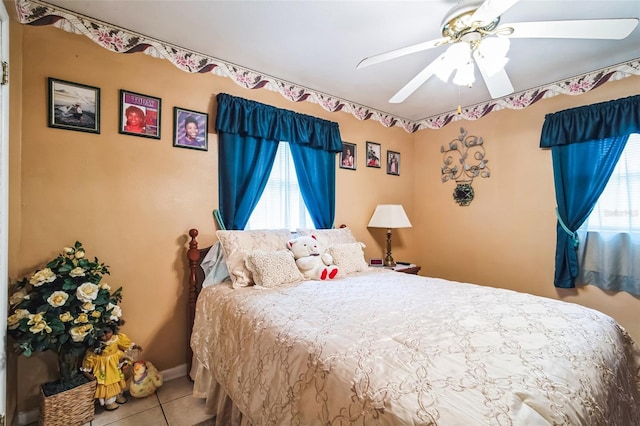 bedroom with baseboards, a ceiling fan, and tile patterned floors