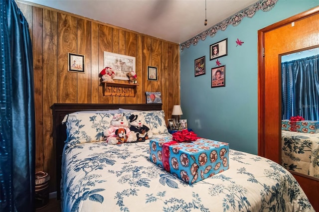 bedroom featuring wood walls