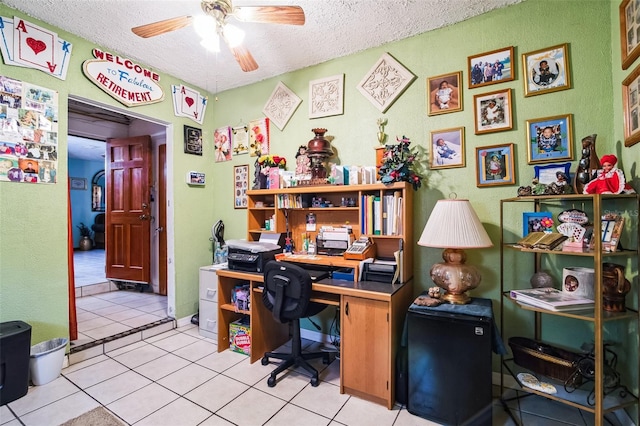 office space with light tile patterned floors, ceiling fan, and a textured ceiling