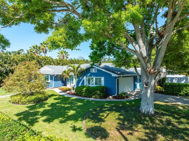 single story home featuring concrete driveway, a front lawn, and a garage