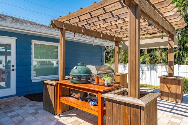 wooden deck featuring a patio area, area for grilling, a pergola, and fence