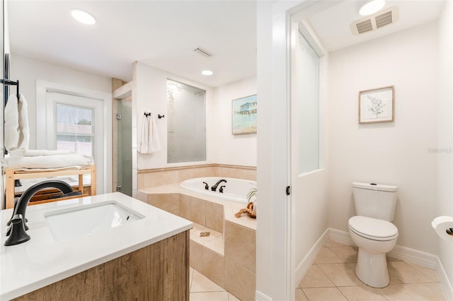 full bath featuring a bath, visible vents, a sink, tile patterned flooring, and toilet