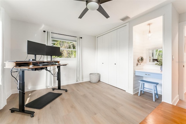 office with a ceiling fan, wood finished floors, and visible vents