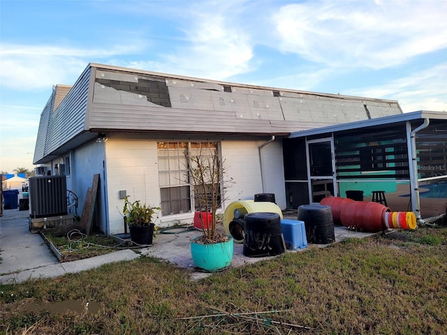 back of property featuring cooling unit and a sunroom