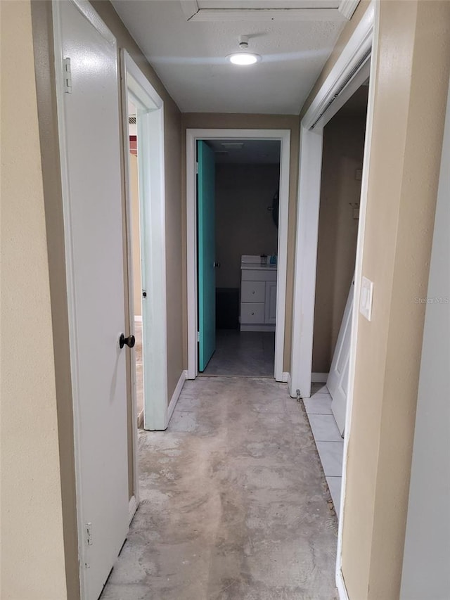 hallway featuring unfinished concrete flooring