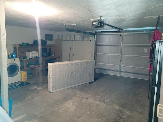 garage with a garage door opener and washer / clothes dryer