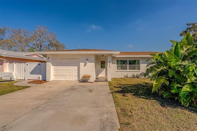 ranch-style house featuring driveway, an attached garage, a gate, fence, and stucco siding