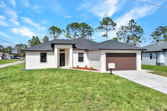 prairie-style house with a front lawn, concrete driveway, an attached garage, and stucco siding