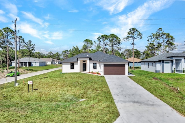 view of front of home featuring a garage, concrete driveway, a front yard, and stucco siding