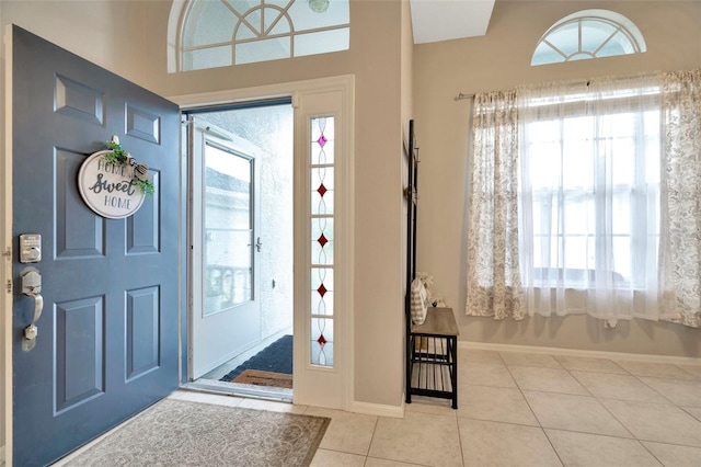 entryway featuring baseboards and tile patterned floors