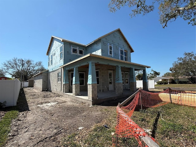 view of front of home featuring fence and a patio