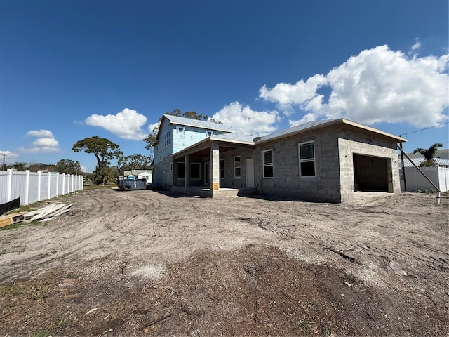 view of front of house featuring a garage and fence