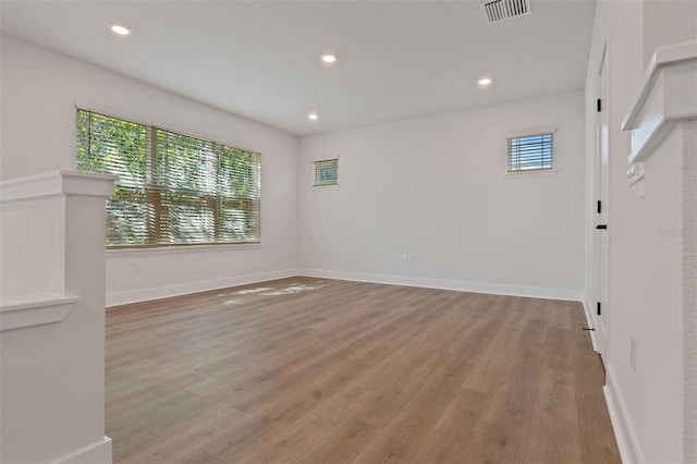 unfurnished room featuring light wood-style flooring, visible vents, and recessed lighting