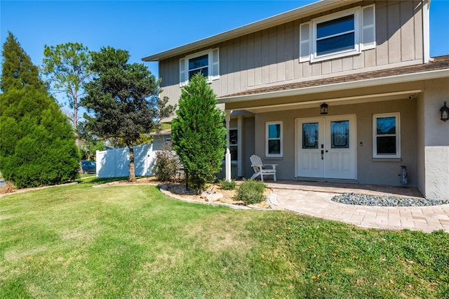 view of front of home with a front lawn and stucco siding