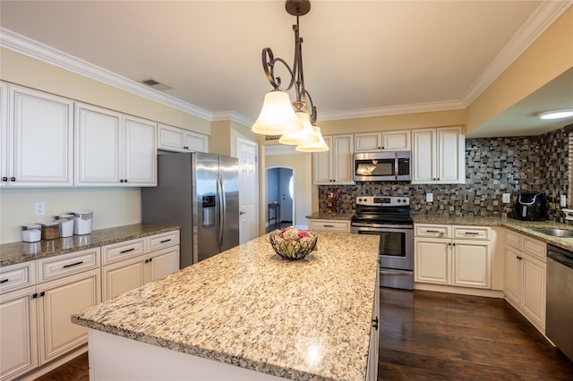 kitchen featuring tasteful backsplash, visible vents, dark wood finished floors, ornamental molding, and appliances with stainless steel finishes