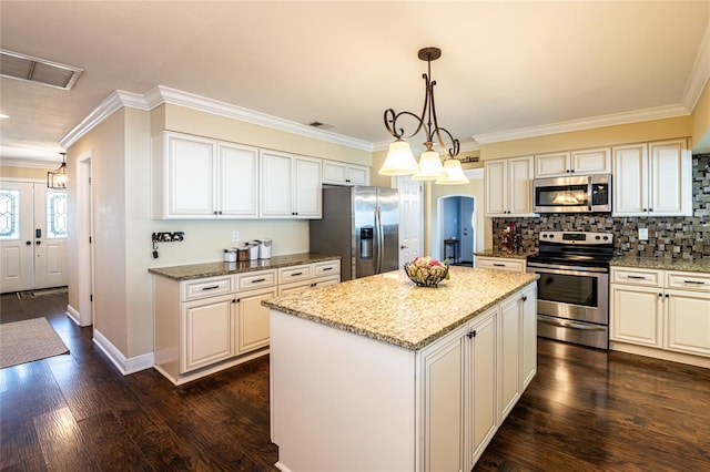 kitchen with visible vents, arched walkways, stainless steel appliances, dark wood-type flooring, and a center island