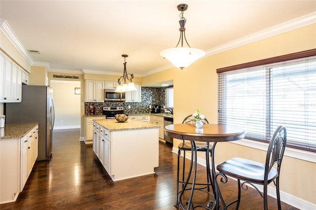 kitchen featuring visible vents, dark wood-style flooring, stainless steel appliances, backsplash, and a center island