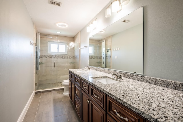 bathroom featuring a sink, visible vents, and baseboards