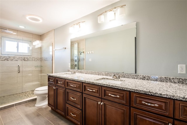 full bath with a shower stall, toilet, double vanity, and a sink