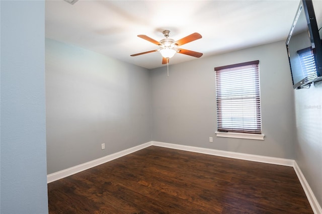 spare room with wood finished floors, baseboards, and ceiling fan