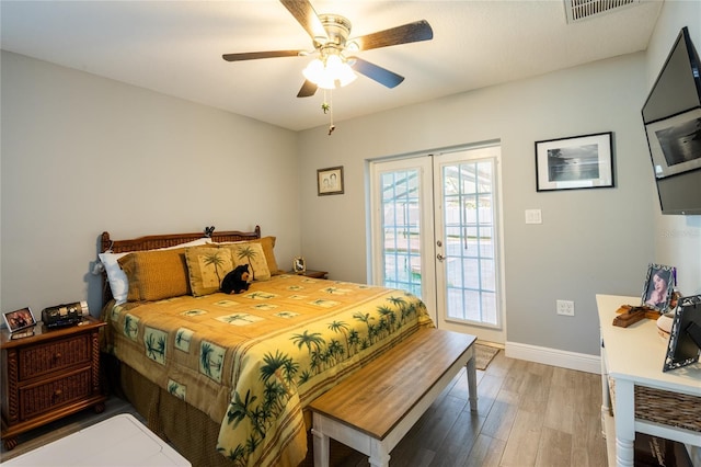 bedroom featuring light wood finished floors, visible vents, ceiling fan, baseboards, and access to outside